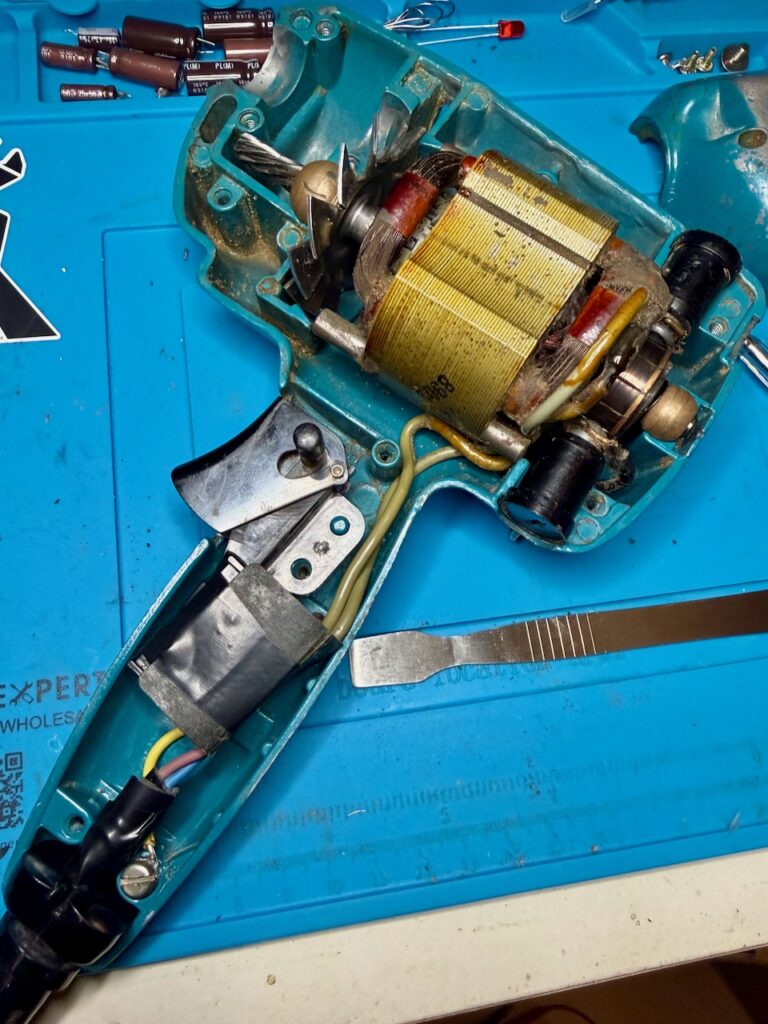 Reassembling the Super D500, showing the new cable connected, the earth connector secured.