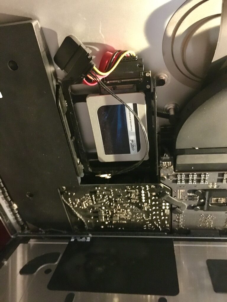 Inside iMac 5K 2019 showing the OWC inline thermal sensor unstuck from the SSD.