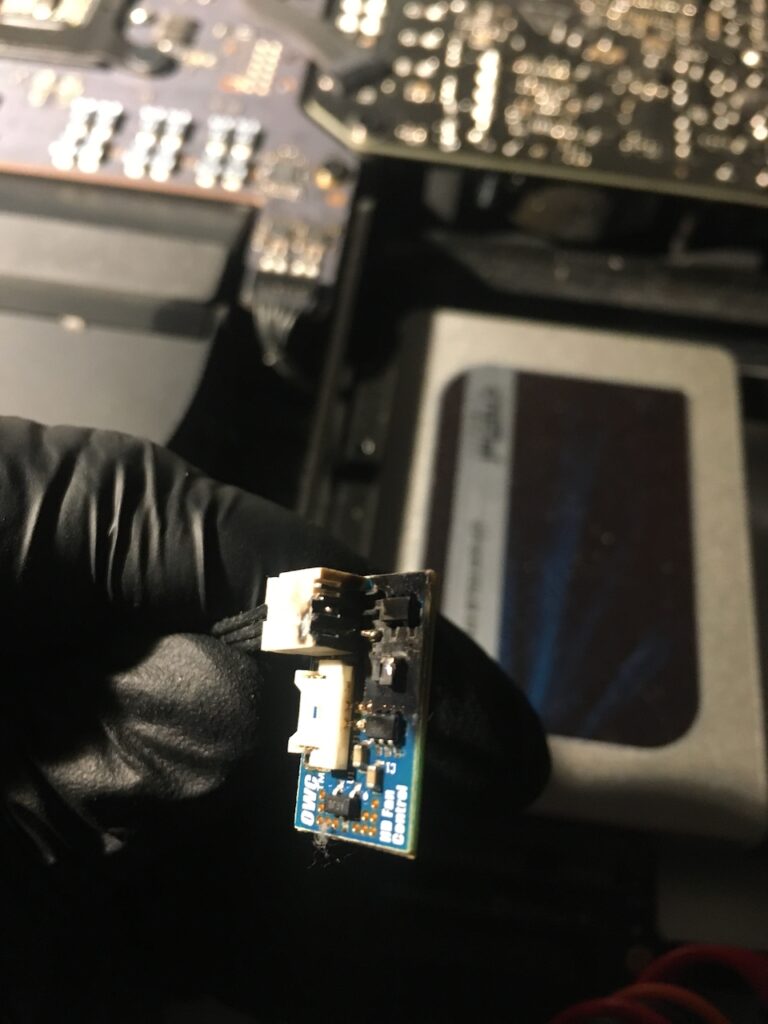 Close up of the OWC in-line digital thermal sensor, showing scorch marks and damaged components