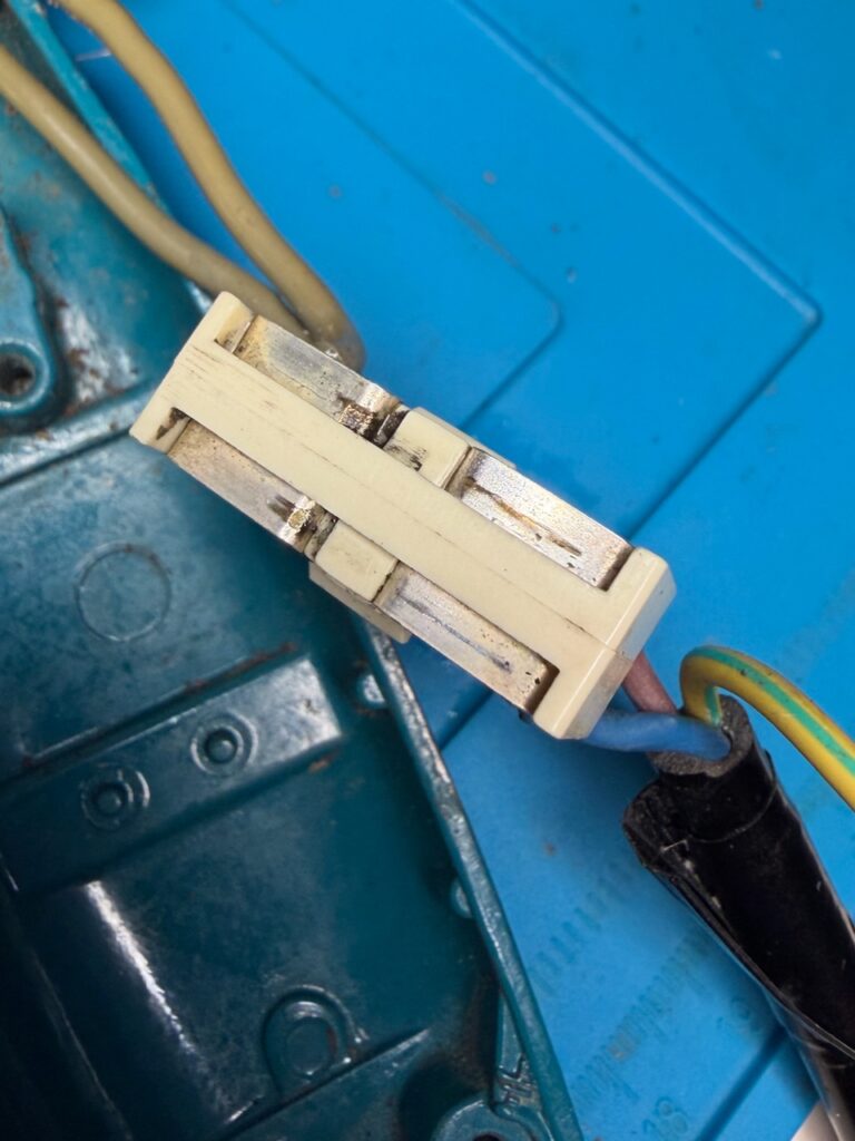 The white contact block clips into the black frame over the sled - and must be done such that the ball bearing remains captive in the recess underneath.