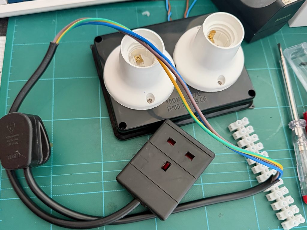 Lamp holders fitted and wired through the junction box lid, with stripped power extension.
